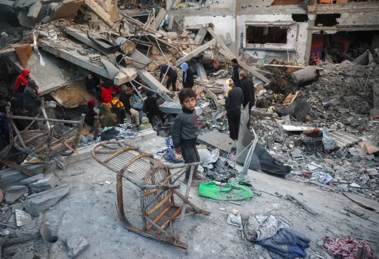 Israel Issues Evacuation Order In Central Gaza 1 A child looks on as people search the rubble of a building destroyed in an Israeli strike on the Bureij camp for Palestinian refugees in the central Gaza Strip on January 8, 2025.