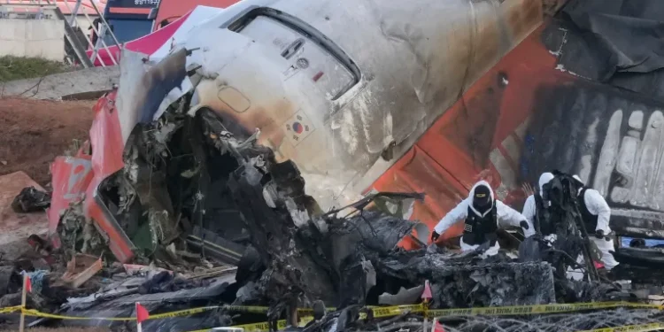 Rescue team members work at the site of a plane crash at Muan International Airport in Muan, South Korea, on December 31, 2024.