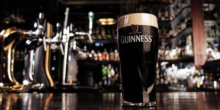 Guinness Ghana Breweries Hits GHS5.60, Marking First Gain of 2025 1 Zoom in on a glass with cold dark Guinness beer with a thin strip of completely settled foam in a Bar. High quality 4k footage