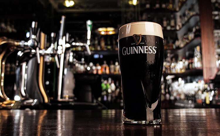 Guinness Ghana Breweries Hits GHS5.60, Marking First Gain of 2025 1 Zoom in on a glass with cold dark Guinness beer with a thin strip of completely settled foam in a Bar. High quality 4k footage