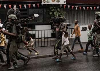 M23 Rebels Seize Goma Airport Amid Escalating Conflict 10 Residents walk alongside members of the M23 armed group in the city of Goma after it was besieged