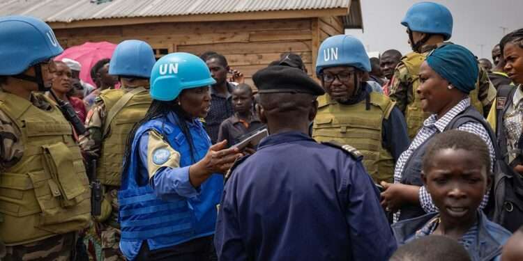 Crisis in Goma, Violence and Despair Grip DRC City 1 UN police officers talk to displaced people in a camp close to eastern Democratic Republic of the Congo provincial capital Goma.
