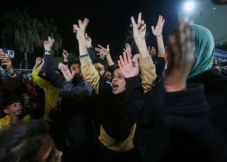 Palestinians in the garden of Al-Aqsa Martyrs Hospital in Gaza gather to celebrate the ceasefire deal.