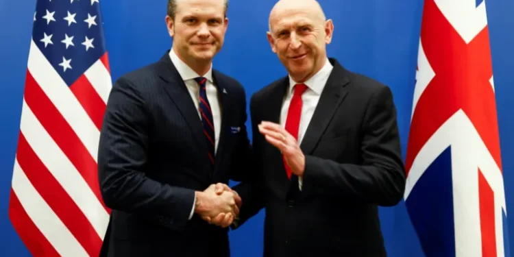 Pete Hegseth shakes hands with his UK counterpart John Healey.