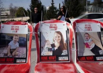 Posters of Shiri Bibas, centre, and her sons Ariel, left, and Kfir.