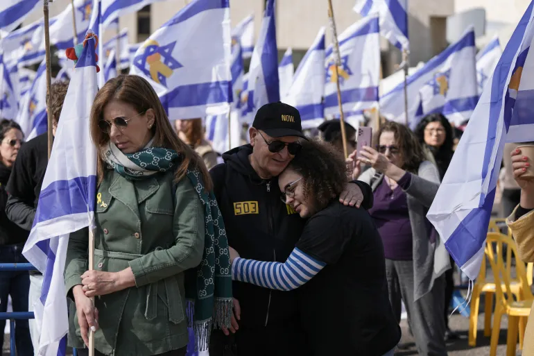 Israelis react as Hamas releases the bodies of four Israeli hostages.