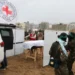 Hamas Releases Bodies Of Four Israeli Hostages 12 A member of the Red Cross stands near a coffin during the handover of the bodies of four Israeli hostages.