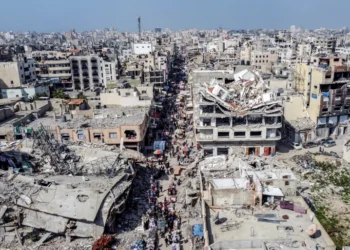 Australia Fears a Vanishing Palestine as Gaza, West Bank Suffer 9 A drone view shows Palestinians walking at a street market near buildings damaged and destroyed during the Israeli offensive, amid the Israel-Hamas ceasefire in Gaza City, February 17, 2025.