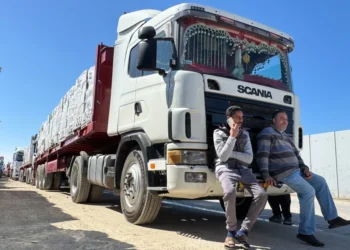 Trucks carrying humanitarian aid line up on the Egyptian side of the Rafah border crossing with the Gaza Strip