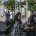 Displaced Palestinians flee an Israeli air raid in Gaza City.