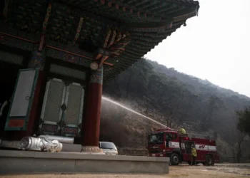 Firefighters work at the Gounsa temple, devastated by a wildfire, in Uiseong county on March 27, 2025 as South Korea Ravaged By Largest Wildfires On Record