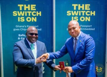 Hon. Julius Debrah recieves his chip-embedded passport from Hon. Samuel Okudzeto Ablakwa, Minister of Foreign Affairs