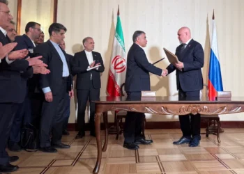 Iranian Oil Minister Mohsen Paknejad and Russian Energy Minister Sergei Tsivilev exchange documents during their meeting in Moscow on Friday as Iran to sign $4bn oilfields deal with Russia