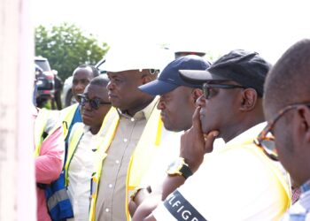 Roads Minister Hon. Governs Kwame Agbodza inspecting the architectural design of the Afraim Plains River Bridge