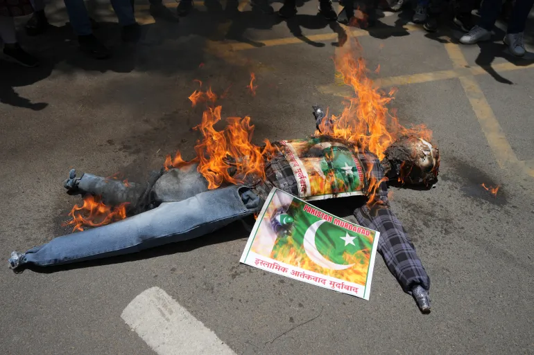 Pakistan Retaliates Against India’s Response To Pahalgam Attack 2 People burn an effigy bearing a Pakistani flag during a protest against the killing of tourists by rebels near Pahalgam, in Ahmedabad, India, on Thursday, April 24, 2025