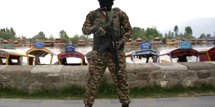 A member of India's security forces stands guard on the banks of Dal Lake in Indian-administered Kashmir after the Pahalgam attack.