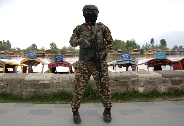 A member of India's security forces stands guard on the banks of Dal Lake in Indian-administered Kashmir after the Pahalgam attack.