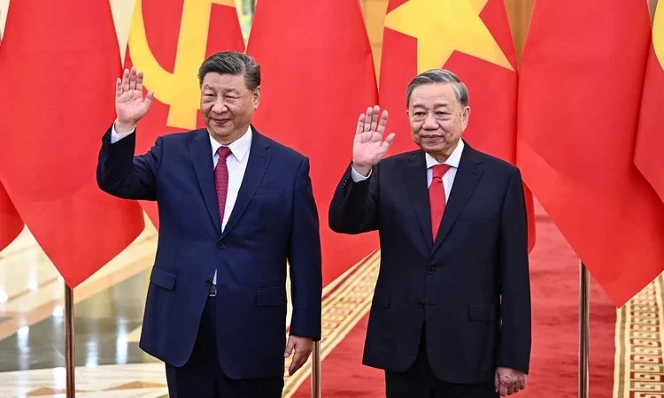 China, Vietnam Sign Dozens Of Agreements 1 Vietnam's communist party General Secretary Tô Lâm (R) and Chinese President Xi Jinping (L) wave during a meeting at the Office of the Party Central Committee in Hanoi as China, Vietnam Sign Dozens Of Agreements