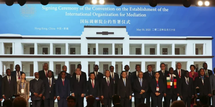 Chinese Foreign Minister Wang Yi, center, attends the signing ceremony of “the Convention on the Establishment of the International Organization for Mediation”, in Hong Kong, Friday, May 30, 2025.