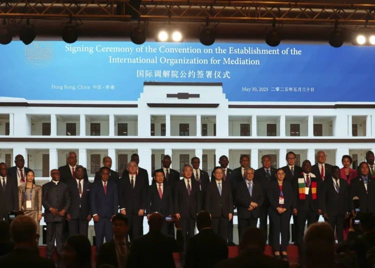 Chinese Foreign Minister Wang Yi, center, attends the signing ceremony of “the Convention on the Establishment of the International Organization for Mediation”, in Hong Kong, Friday, May 30, 2025.