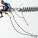 Copper Emerges As World’s Next Strategic Prize 14 A worker in the Philippines installs a new electric cable atop a pylon.