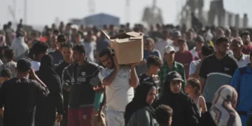 Palestinians carry boxes containing food and humanitarian aid packages delivered by the Gaza Humanitarian Foundation, a US-backed organisation approved by Israel, in Rafah, southern Gaza Strip, on Tuesday, May 27, 2025.