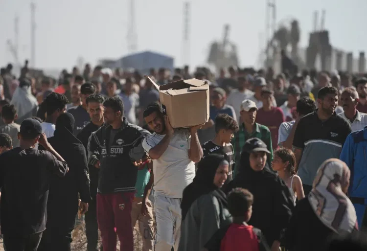 Deadly Rush Confirms Fears About Gaza Humanitarian Foundation 1 Palestinians carry boxes containing food and humanitarian aid packages delivered by the Gaza Humanitarian Foundation, a US-backed organisation approved by Israel, in Rafah, southern Gaza Strip, on Tuesday, May 27, 2025.