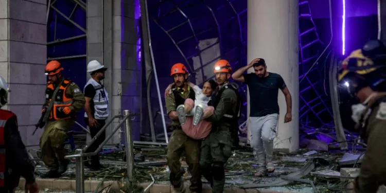 Iran Launches Fresh Wave Of Retaliatory Attacks On Israel 1 Rescuers evacuate an injured woman from an impacted residential building following a missile attack from Iran on Israel, central Israel, June 16, 2025.