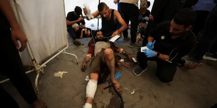 Gaza's Only Catholic Church Struck By Israeli Forces 1 People being attended to following the Israeli attack on The Church of the Holy Family