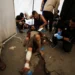 People being attended to following the Israeli attack on The Church of the Holy Family