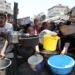 Palestinian children wait to receive food from a charity kitchen in Gaza City, July 24.