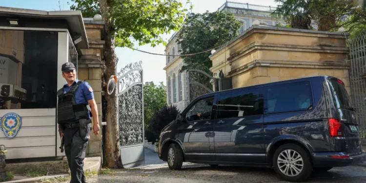 A Turkish policeman stands guard as a vehicle enters the Iranian consulate, where Iran is holding nuclear talks with the so-called E3 group of France, UK and Germany, in Istanbul, Turkiye, July 25, 2025.
