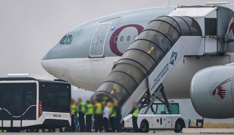 Germany Deports 81 Afghan Nationals 1 People board a Qatar Airways plane.