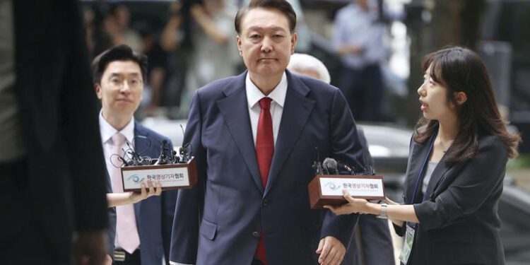 South Korea's former impeached president Yoon Suk Yeol, centre, arrives at a court to attend a hearing to review his arrest warrant requested by special prosecutors, in Seoul on July 9, 2025.