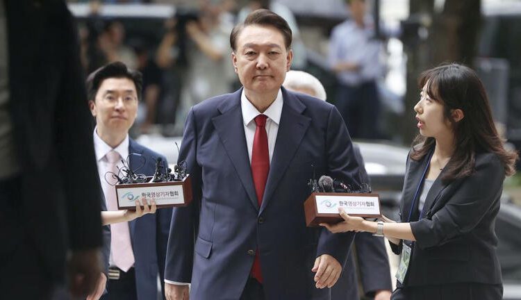 South Korea's former impeached president Yoon Suk Yeol, centre, arrives at a court to attend a hearing to review his arrest warrant requested by special prosecutors, in Seoul on July 9, 2025.