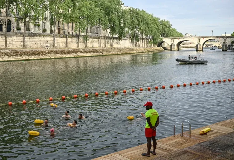 River Seine Reopens 1 A lifeguard stands on duty as people swim at the Pont Marie safe bathing site on the River Seine on its opening day, in Paris, France on July 5, 2025.