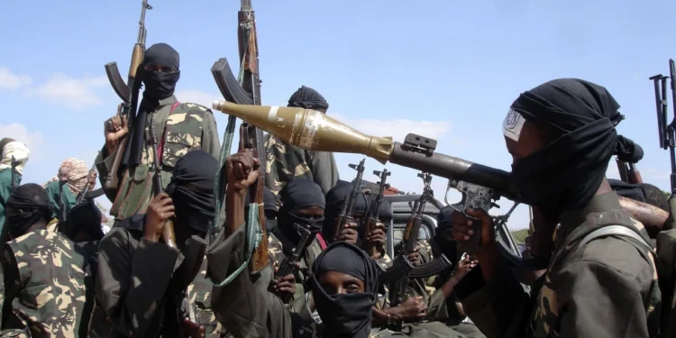 Armed al-Shabab fighters ride on pickup trucks as they prepare to travel into the city.