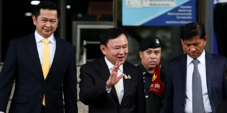 Former Thai Prime Minister Thaksin Shinawatra, centre, leaves court in Bangkok, Thailand, after he was cleared of charges in a lese-majeste case, also known as a royal insult case, on Friday.