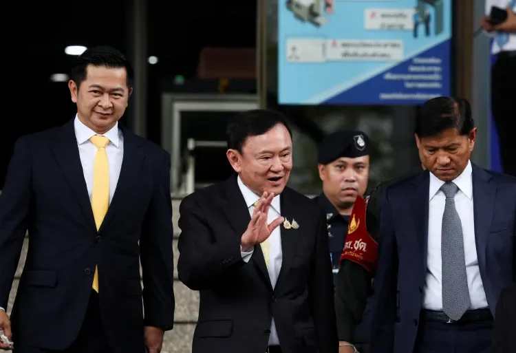 Former Thai Prime Minister Thaksin Shinawatra, centre, leaves court in Bangkok, Thailand, after he was cleared of charges in a lese-majeste case, also known as a royal insult case, on Friday.