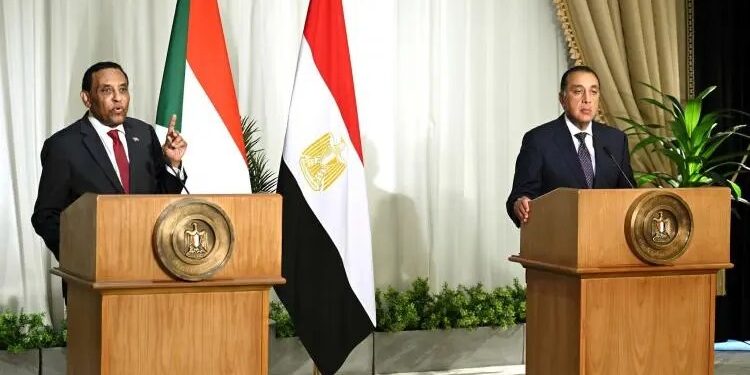 Prime Minister Kamil al-Taib (left) and Prime Minister Mustafa Madbouly (right)