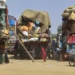 Afghan refugee children play next to trucks loaded with their family’s belongings as they wait to return Afghanistan along a highway in Landi Kotal, Pakistan, April 9, 2025.