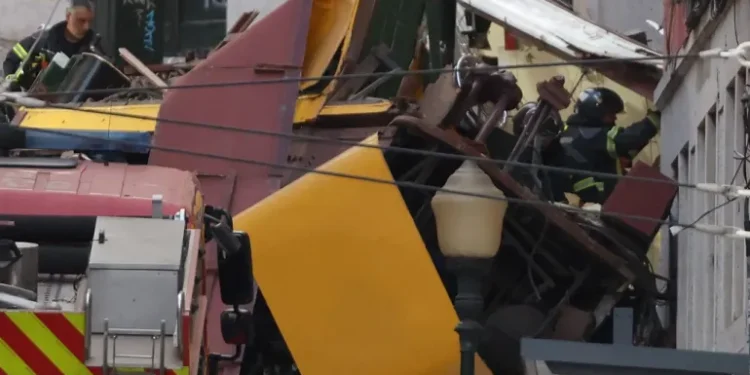 Police and firefighters work at the site of a funicular accident in Lisbon.