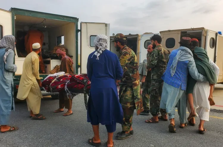 Countries Offer Condolences As Earthquake In Eastern Afghanistan Kills At Least 800 1 Soldiers and civilians carry earthquake survivors to an ambulance at an airport in Jalalabad.