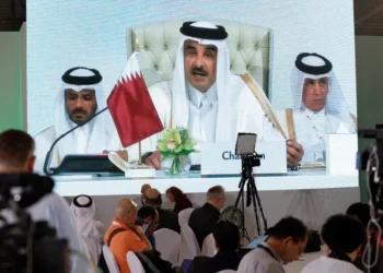 Journalists watch on a screen at the media center as Sheikh Tamim bin Hamad Al Thani, the emir of Qatar, speaks