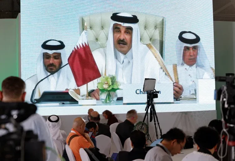 Qatar's Emir Vows Economic Resilience Amid Regional Crisis 1 Journalists watch on a screen at the media center as Sheikh Tamim bin Hamad Al Thani, the emir of Qatar, speaks