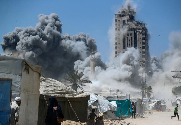 Israel Strikes High-Rise Building In Gaza City Offensive 1 A man runs as smoke rises after a building is hit by an Israeli air strike, in Gaza City on Friday, September 5.
