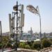 Communications Blackout Hits Afghanistan In Latest Taliban Crackdown 14 A Taliban flag flutters near telecom equipment installed over a rooftop providing internet services overlooking Hazrat-e-Ali Shrine, or Blue Mosque, in Mazar-i-Sharif on September 16, 2025, as the Taliban administration banned fibre-optic internet in Balkh province.