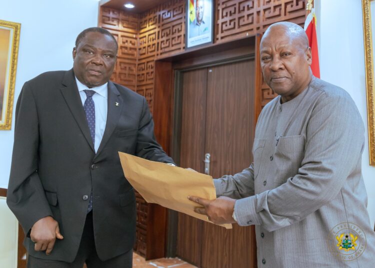 President Mahama receiving the Committee's report from Justice Gabriel Pwamang Scot