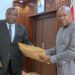 President Mahama receiving the Committee's report from Justice Gabriel Pwamang Scot