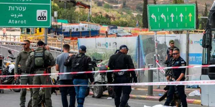 Six People Killed In Jerusalem Shooting Attack 1 Israeli forces gather by a body next to a bus at Ramot Junction in occupied East Jerusalem on September 8, 2025.